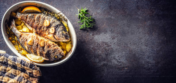 Roasted mediterranean fish bream with potatoes rosemary and lemon