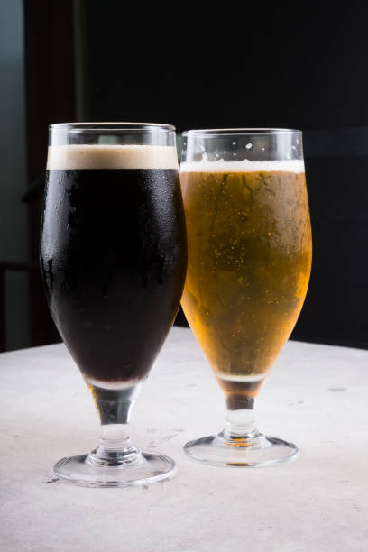 istock Dark and light beer glasses on a table 1170649335