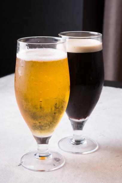 istock Dark and light beer glasses on a table 1170649509