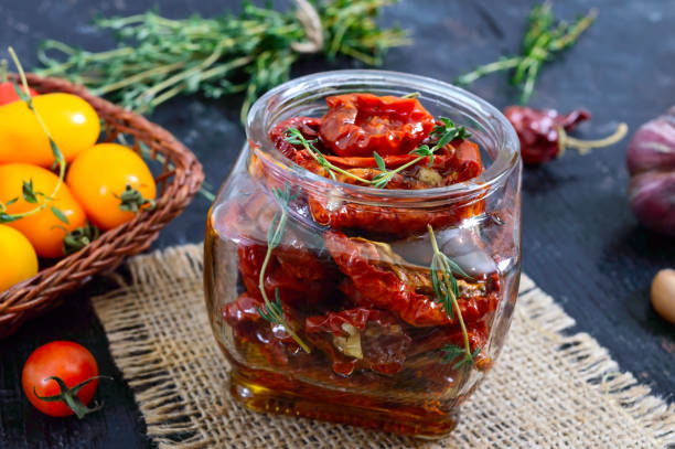 sun-dried tomatoes with herbs, garlic in olive oil in a glass jar. - restaurant pasta italian culture dinner imagens e fotografias de stock