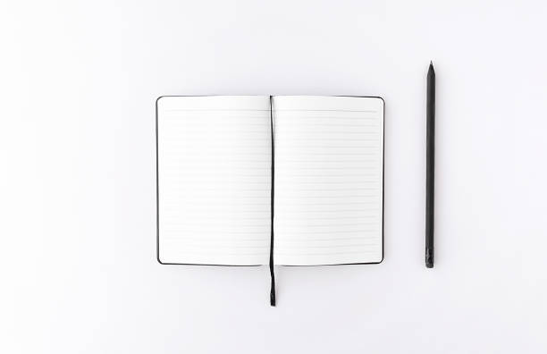 istock Top view of opened notepad with black pencil white background. Mockup for your design. 1170651561