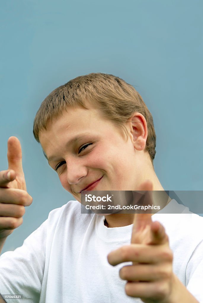 Smiling Boy Pointing Smiling boy pointing, selective focus 14-15 Years Stock Photo