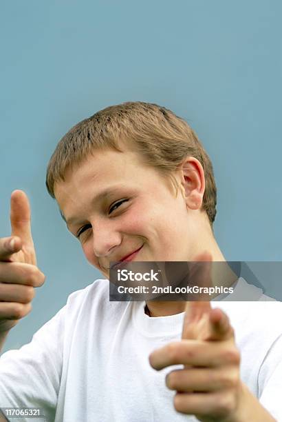 Smiling Boy Pointing Stock Photo - Download Image Now - 14-15 Years, Cheerful, Cheesy Grin