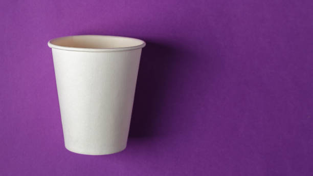 empty white paper cup on vivid purple background - paper glass imagens e fotografias de stock