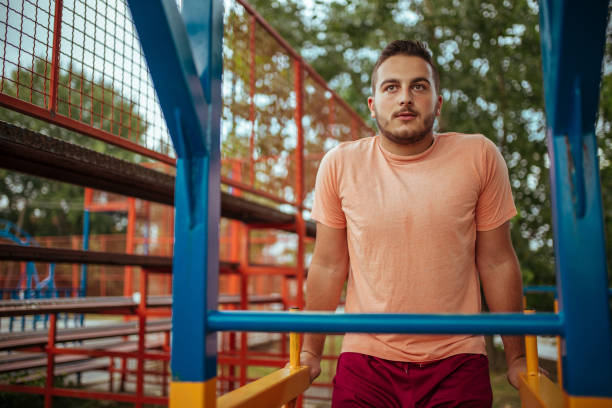 istock Overweight man exercising. The effort pays off! 1170658023