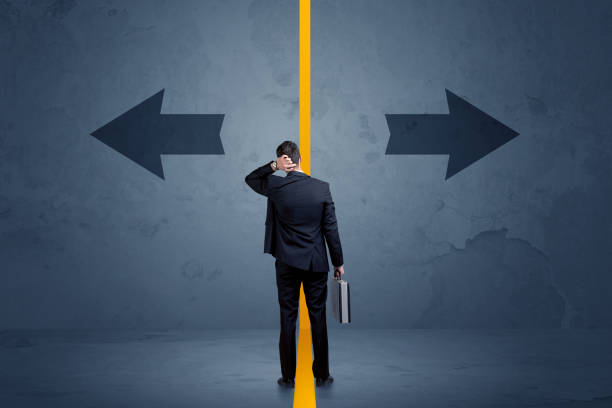 istock Business person choosing between two options separated by a yellow border arrow 1170660135