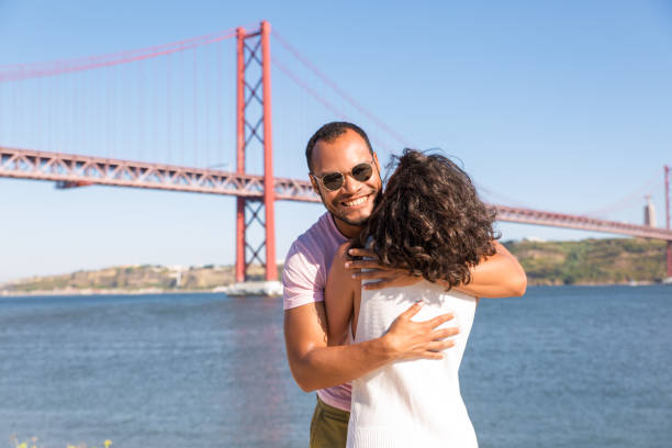 istock Joyful handsome Latin man embracing girlfriend outdoors 1170660324