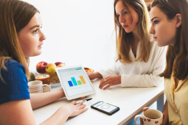 istock three young woman looking at stats on digital tablet 1170660695