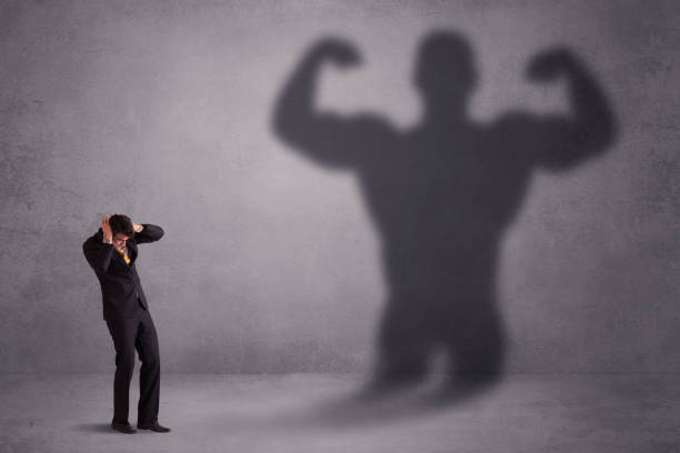 istock Business man looking at his own strong fit shadow concept 1170661989