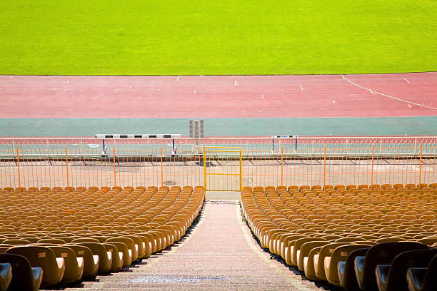 istock Green grass playing field and  empty bleachers at  stadium 117066290