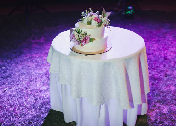 istock A beautiful wedding cake, decorated with roses, stands on a round table in a restaurant. Wedding party. Tasty pie. 1170667073