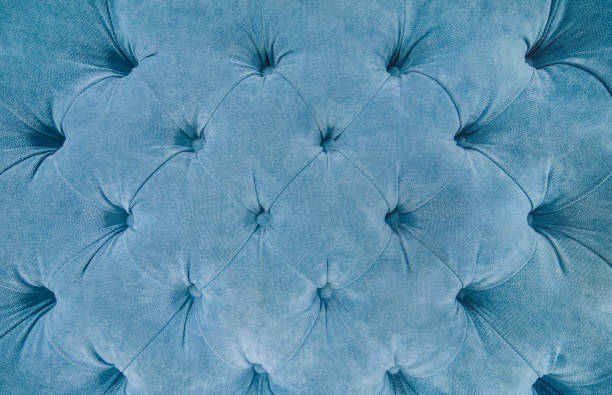 istock Sofa texture background. Blue fabric upholstey texture with buttons. copy space. Velour. 1170667899