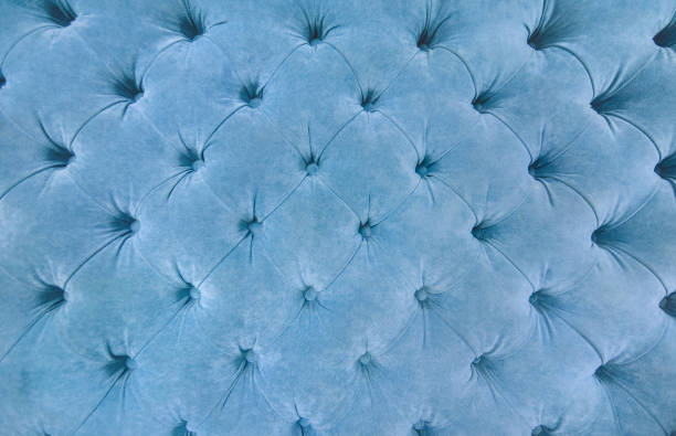 istock Sofa texture background. Blue fabric upholstey texture with buttons. copy space. Velour. 1170667900