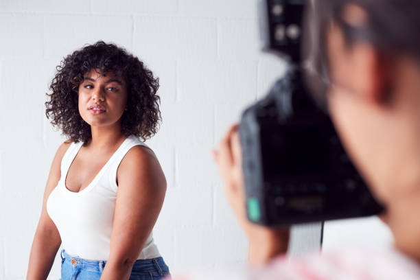 istock Model Posing For Female Photographer In Studio Portrait Session 1170669466