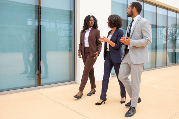 istock Multiethnic business people walking and talking 1170669546
