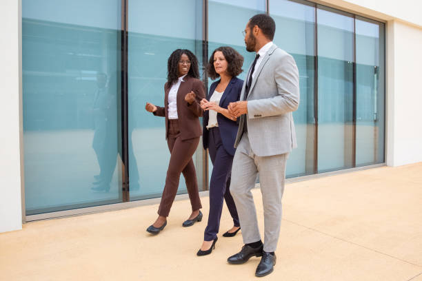 istock Multiethnic business colleagues walking and talking 1170669782