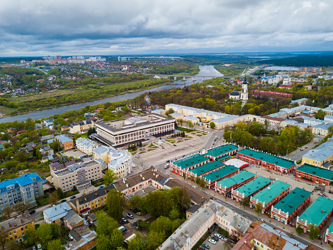 Aerial panoramic view of modern cityscape of Kaluga on banks of Oka river overlooking black domes of Holy Trinity Cathedral