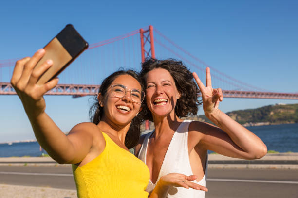 istock Happy female friends posing for selfie 1170672854
