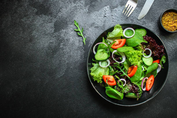 istock healthy salad (tomato, cucumber, mix leaves, onions and other ingredients) top menu concept. food background. copy space 1170675369