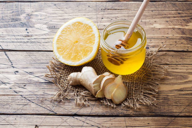 istock Lemon honey and ginger root on wooden background with copy space. Ingredients for a tonic vitamin drink. 1170675750
