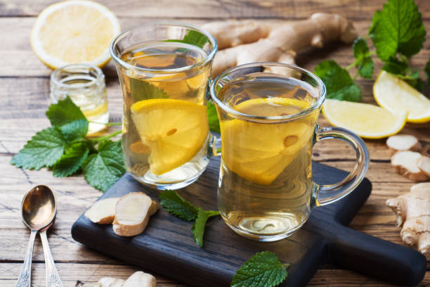 two cups of natural herbal tea ginger lemon mint and honey on a wooden background. - ginger tea cup cold and flu tea imagens e fotografias de stock
