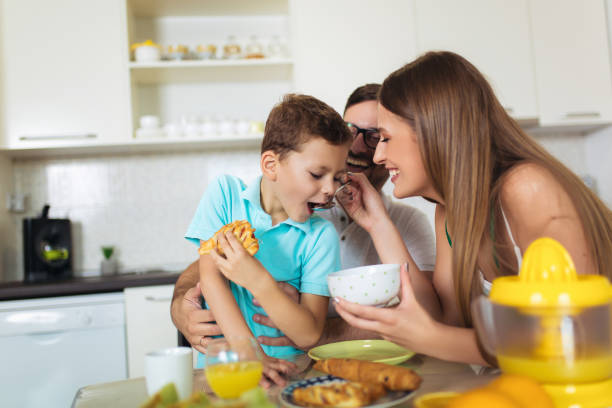 istock Family Eating Breakfast At Kitchen Table 1170677470