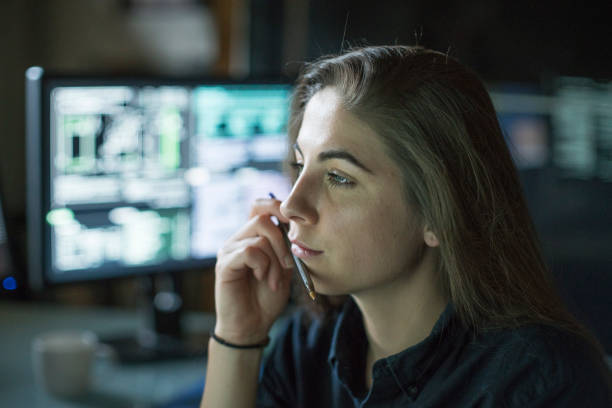 istock Woman monitors dark office 1170678913