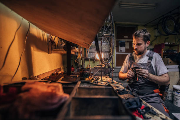 istock Man bicycle mechanic works alone 1170679803
