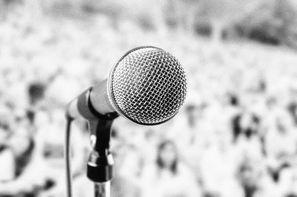 Microphone at outdoor music festival, with heavy film grain Dynamic mic at an outdoor show. microphone stand photos stock pictures, royalty-free photos & images
