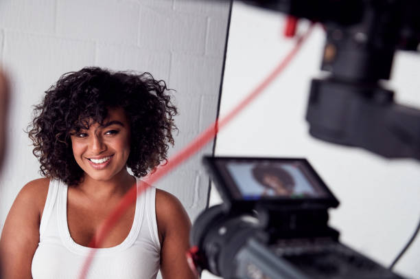 istock Female Model Posing For Video Camera On Film Set 1170680140