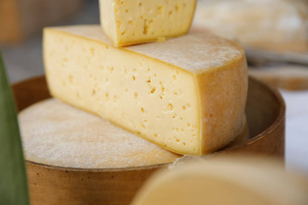 istock Parmesan cheese cut in half on wood plate. 1170683309