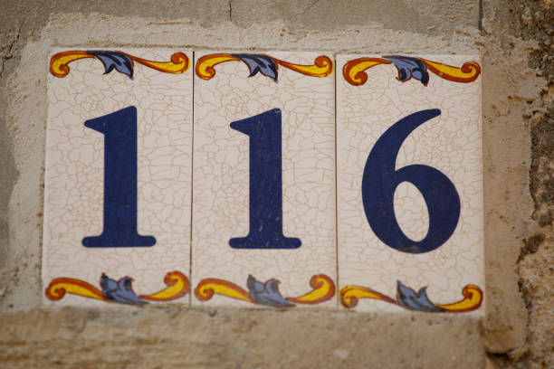 istock Number 116 street address tile on old wall. 1170683366