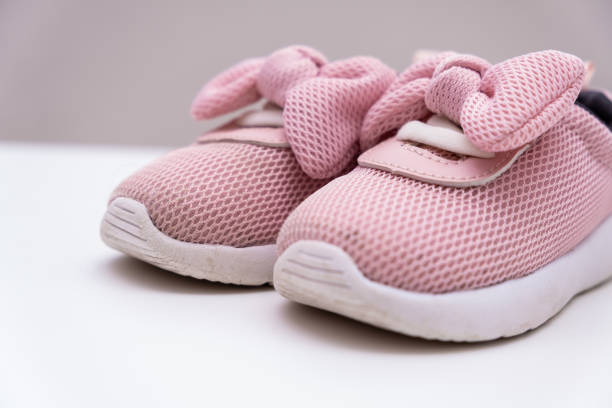 istock Pink baby sneakers on a white background, copy space 1170683367