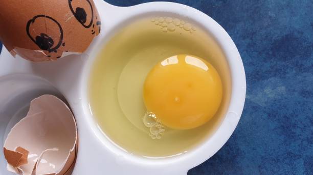 istock Raw egg in poaching dish on blue background with copy space 1170683470