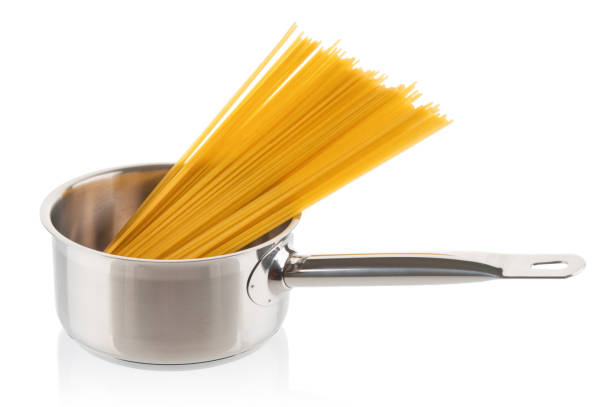 istock Dry spaghetti in stainless saucepan close up on white background 1170683524