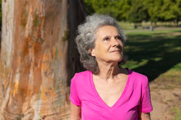 istock Pensive old lady enjoying outdoor walk 1170687410