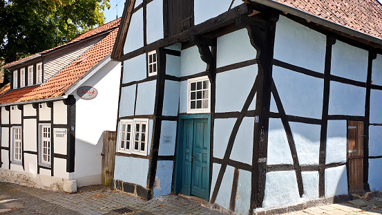 Tecklenburg, Germany - 27 July, 2019: A half-timbered house from the Middle ages, painted blue, in the village center of Tecklenburg in North Rhine-Westphalia and  Münsterland.