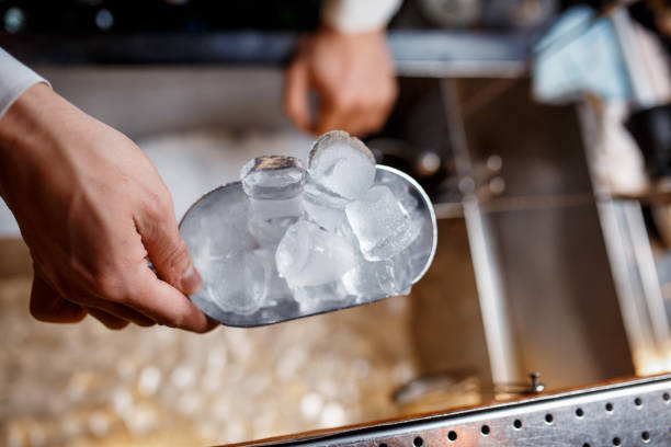 istock barman scoops up ice for making alcohol cocktail 1170688304