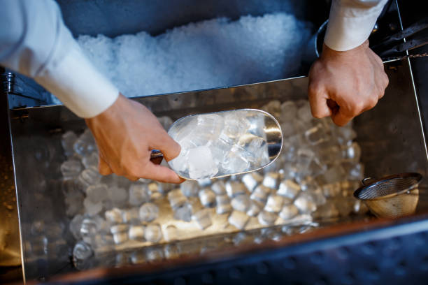 istock barman scoops up ice for making alcohol cocktail 1170688324