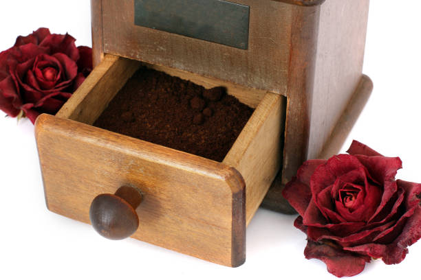 Brewing Coffee at Home - Taking the coffee powder from the coffee millTaken in natural light. Wooden table.