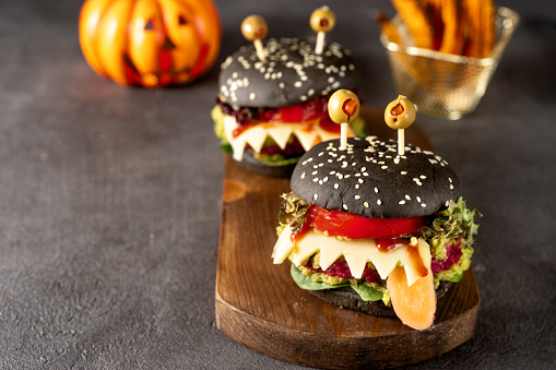 Burger monster for Halloween celebration on dark