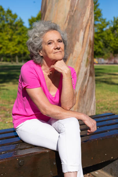 istock Pensive tired old lady posing in park 1170692486