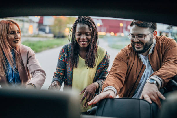 istock Friends packing bags in car trunk 1170692502
