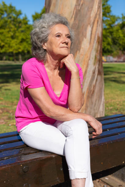 istock Pensive serene old lady relaxing in park 1170694480