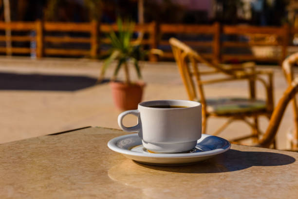 istock Cup of coffee on a table in street cafe 1170694557