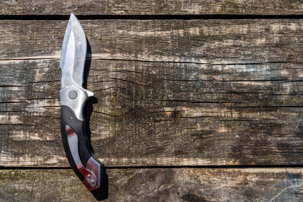istock Folding knife on the rustic wooden background 1170695049