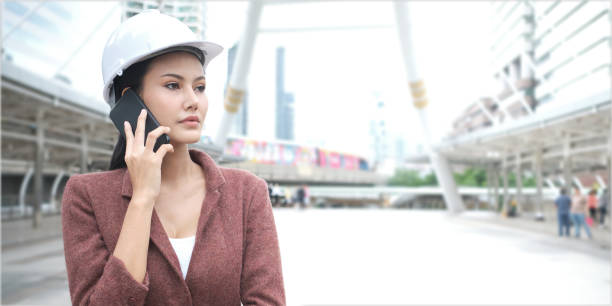 istock Asian working woman is wearing helmet and using cellphone. 1170695872