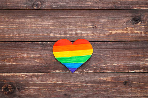 istock Rainbow paper heart on brown wooden table 1170697281