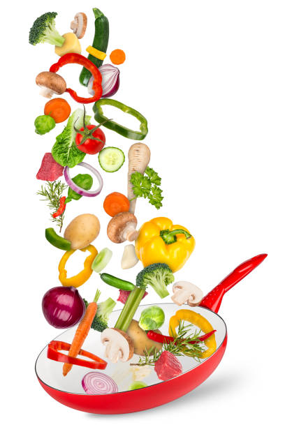 istock fresh ingredients falling flying into red frying pan creative cooking concept isolated white background 1170697595