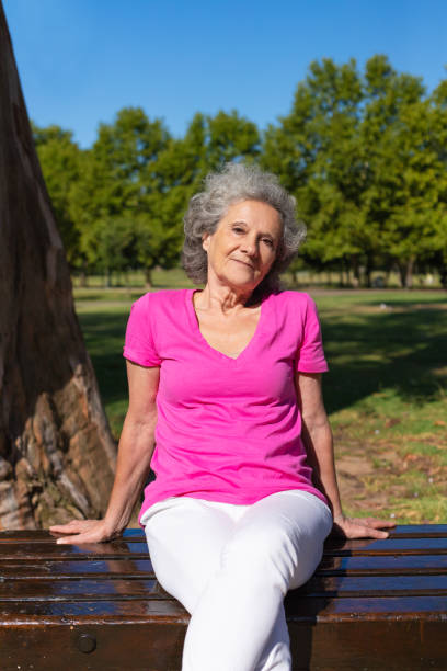 istock Peaceful old lady posing in park 1170697615